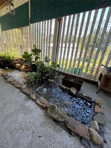 Covered Pergola with active koi pond that feeds hydroponics