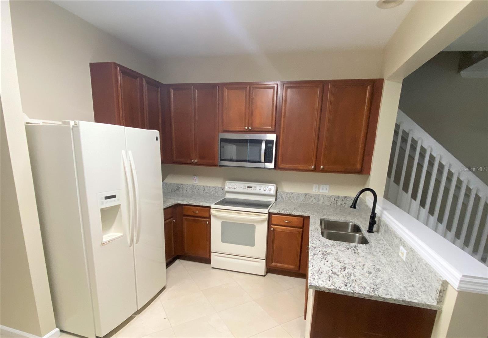 Kitchen with new granite counter and faucet