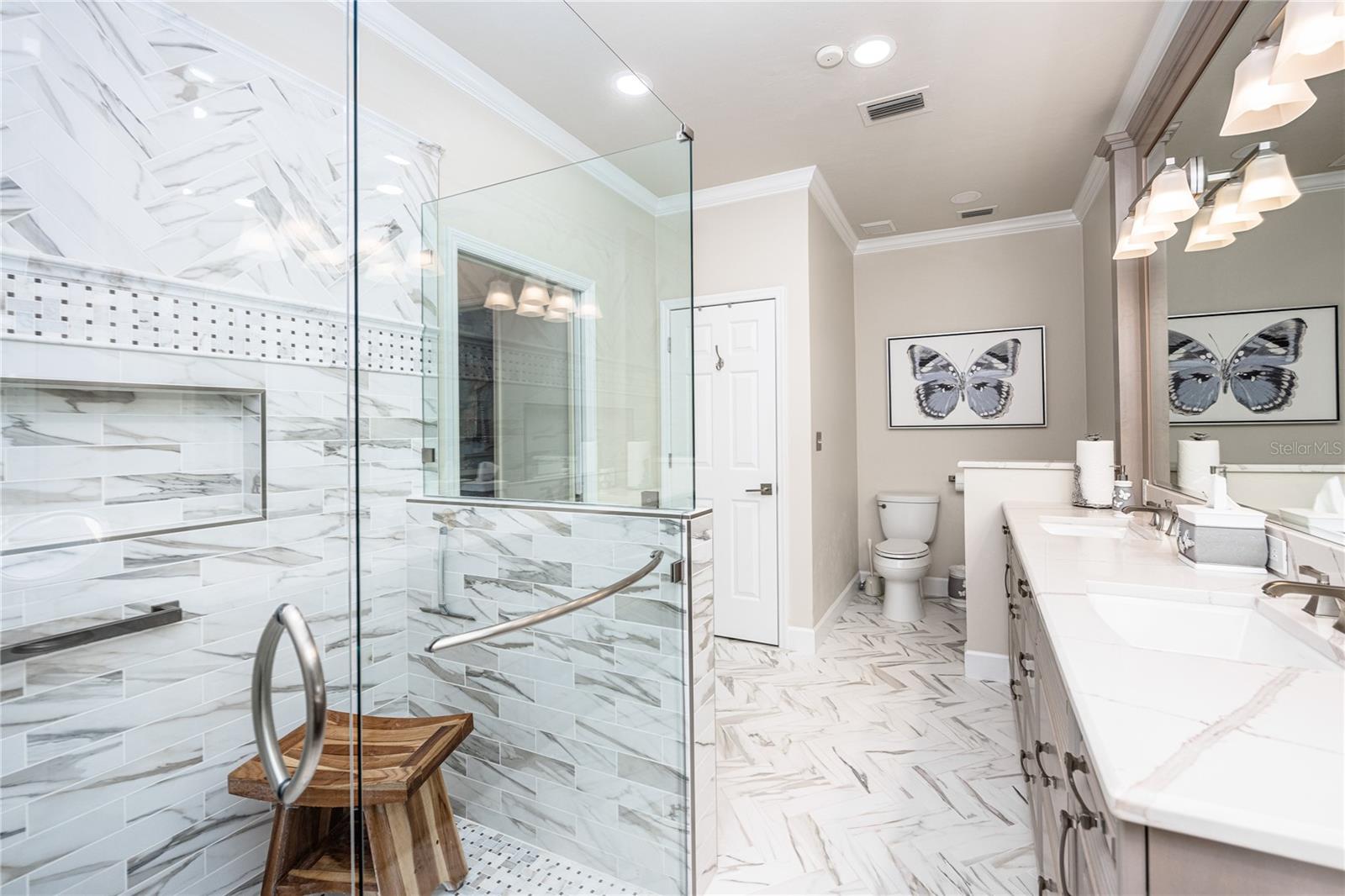 Two vanities, seemless glass shower surround, makeup station, linen closet, bidet