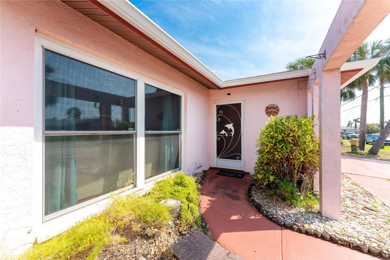Covered Entry passing large Living Room newer windows