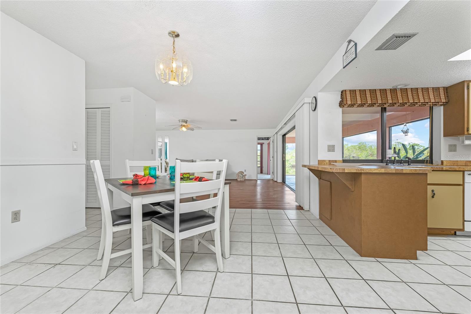 Dining Area With Kitchen to right & Great Room beyond.