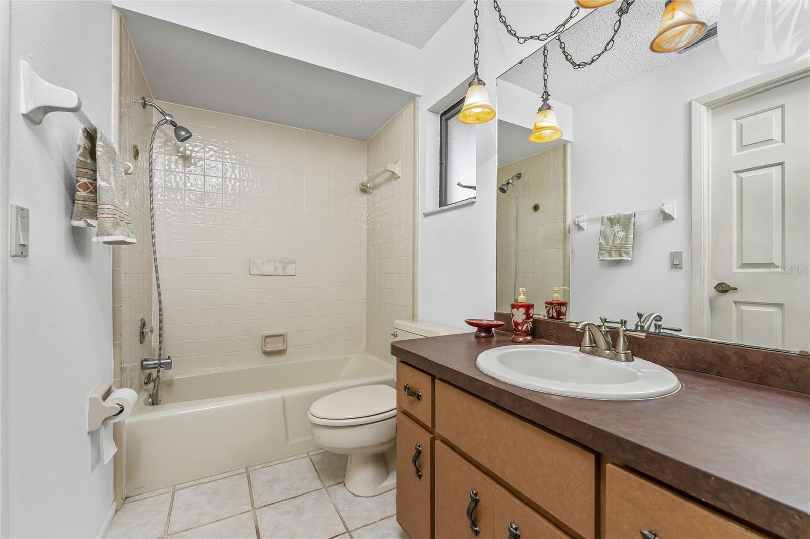Owner suite features vanity, tub/shower & side windows.
