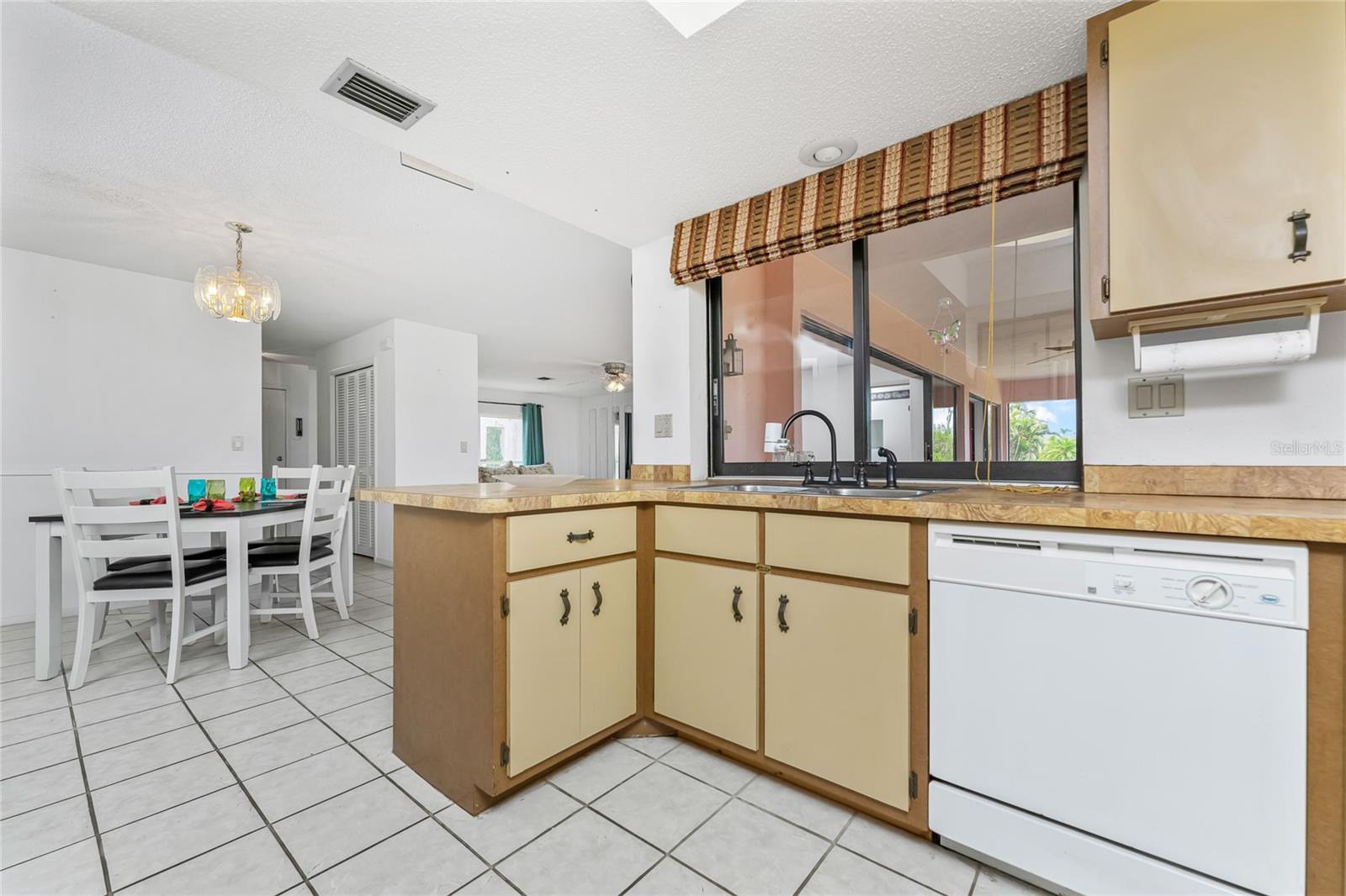 Kitchen & Dining area with pass-thru window to Lanai.