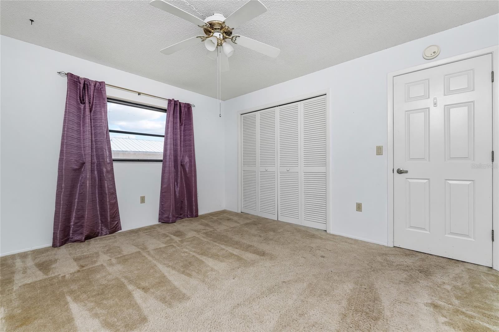 Bedroom 2 with side window & closet.