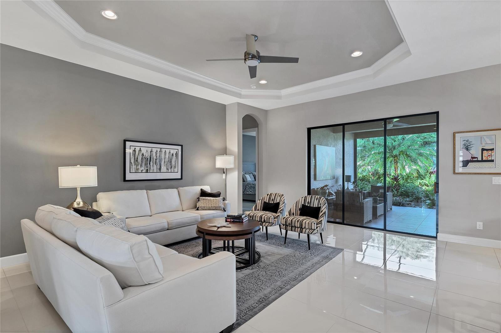 Generous Great Room With Trey Ceiling Offers Beautiful View Of The Water Feature In The Lanai
