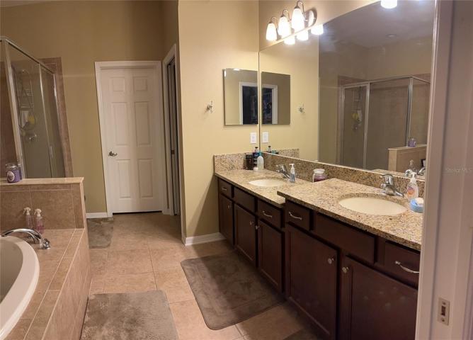 Master Bath. Closed Door Leads to an Enormous Walk in Closet and Open Door to Private Comode Room