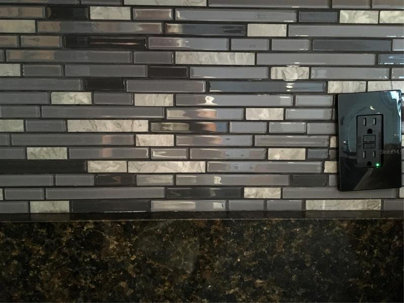 Glass backsplash in kitchen