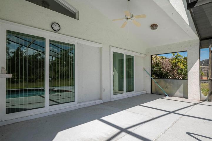 Covered lanai. Upgraded Low-E impact rated sliding, pocket door to the living room.