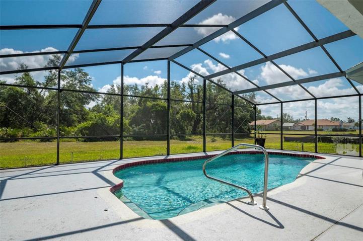 Screen enclosed pool cage with spacious deck with room for table, chairs, lounging and entertaining.