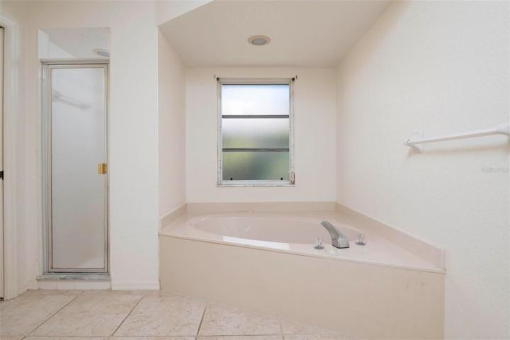Master bathroom, separate Jetted tub, single hung window and separate shower.