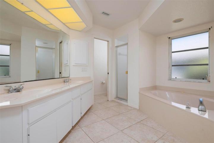 Master en-suite bathroom with dual sinks, jetted tub and separate shower.