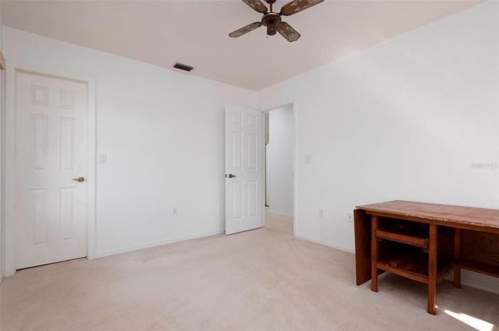 Bedroom #2 with full length closet & ceiling fan.