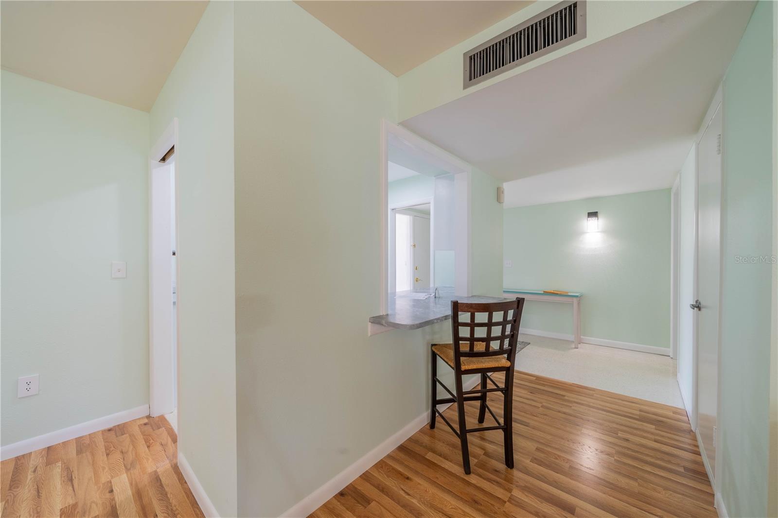 HALLWAY FROM FOYER TO LIVING AREA HAS HARD WOOD LAMINATE FLOORING