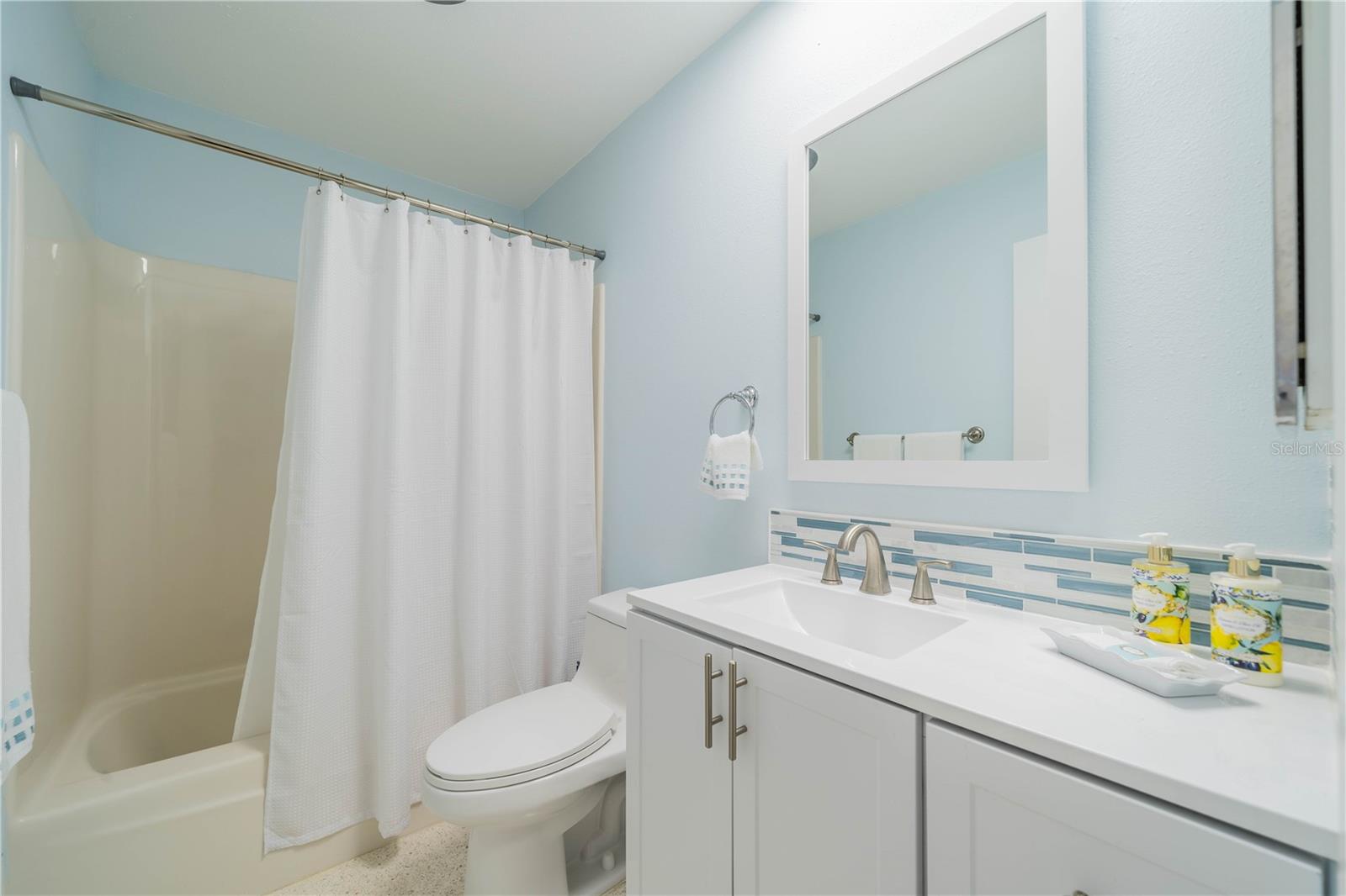 GUEST BATH HAS NEW VANITY, LIGHTS, MIRROR AND COMMODE