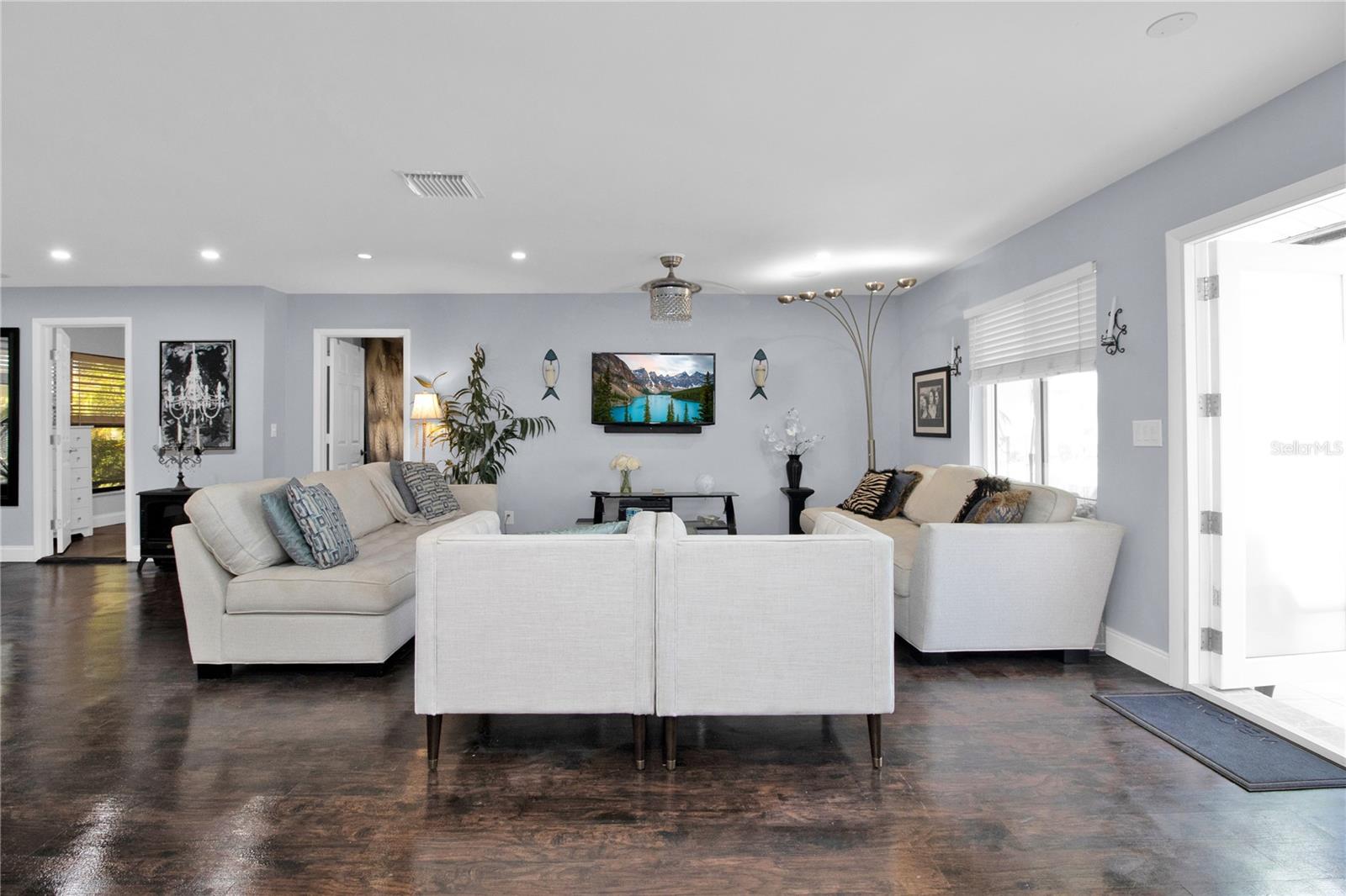 great room - dark wood floors replaced with Grey LV Plank