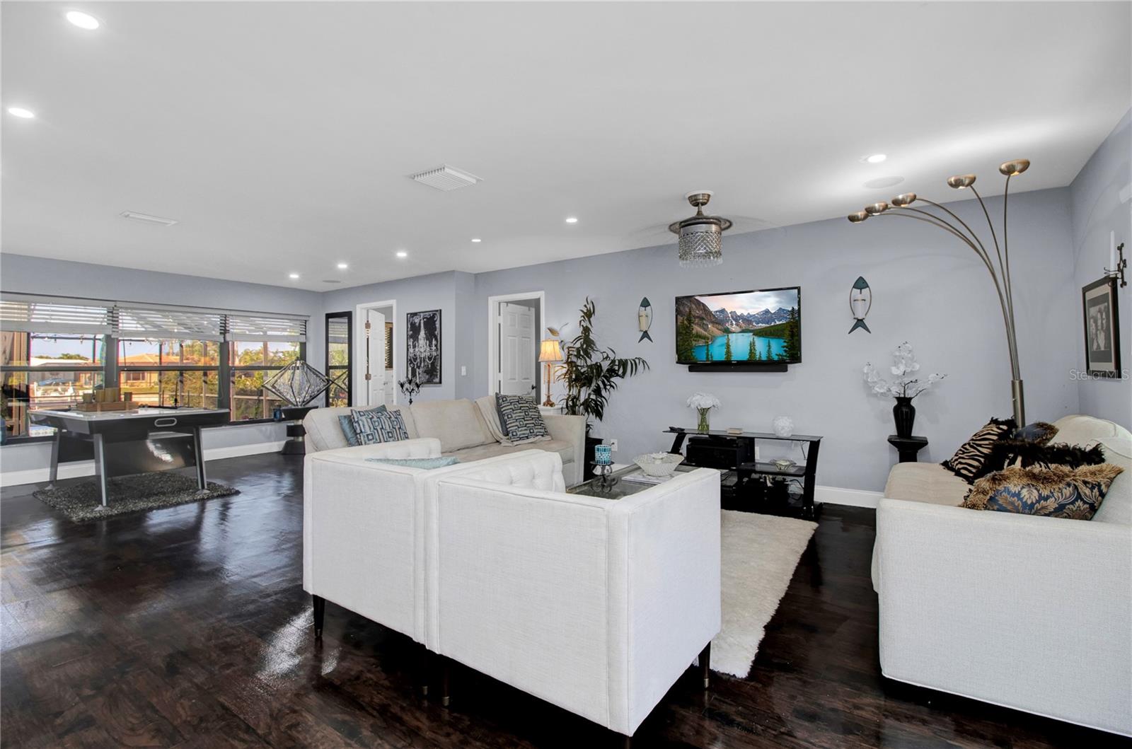 great room - dark wood floors replaced with Grey LV Plank