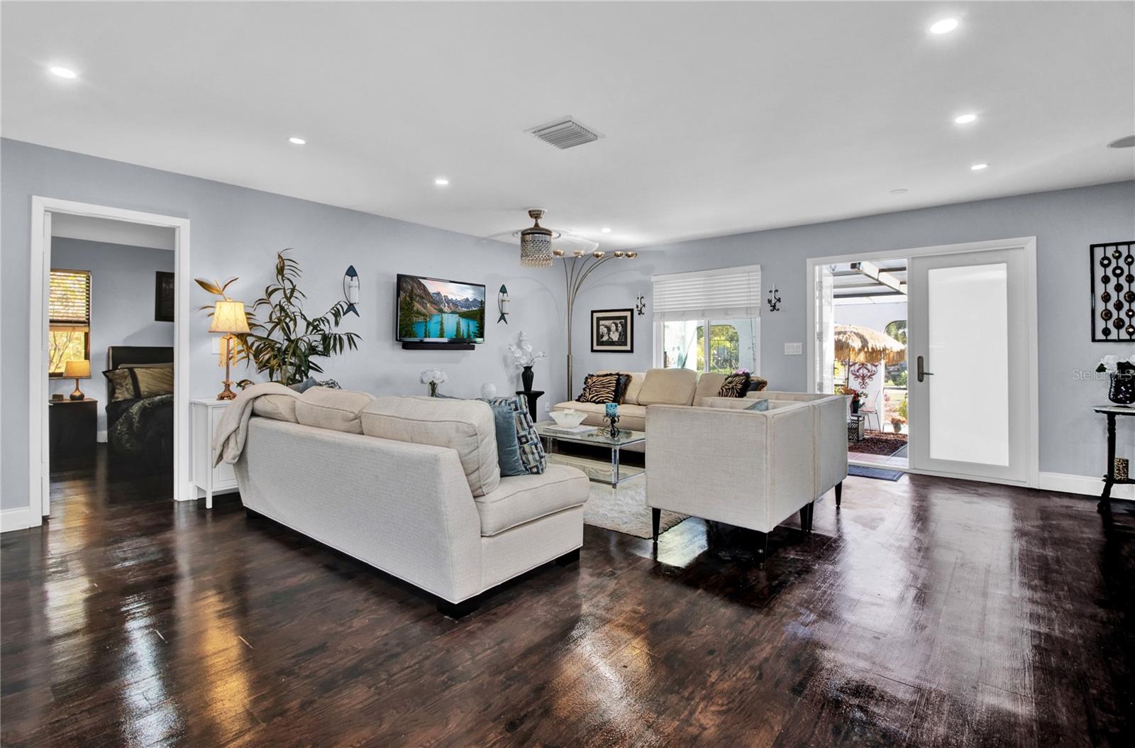 great room - dark wood floors replaced with Grey LV Plank