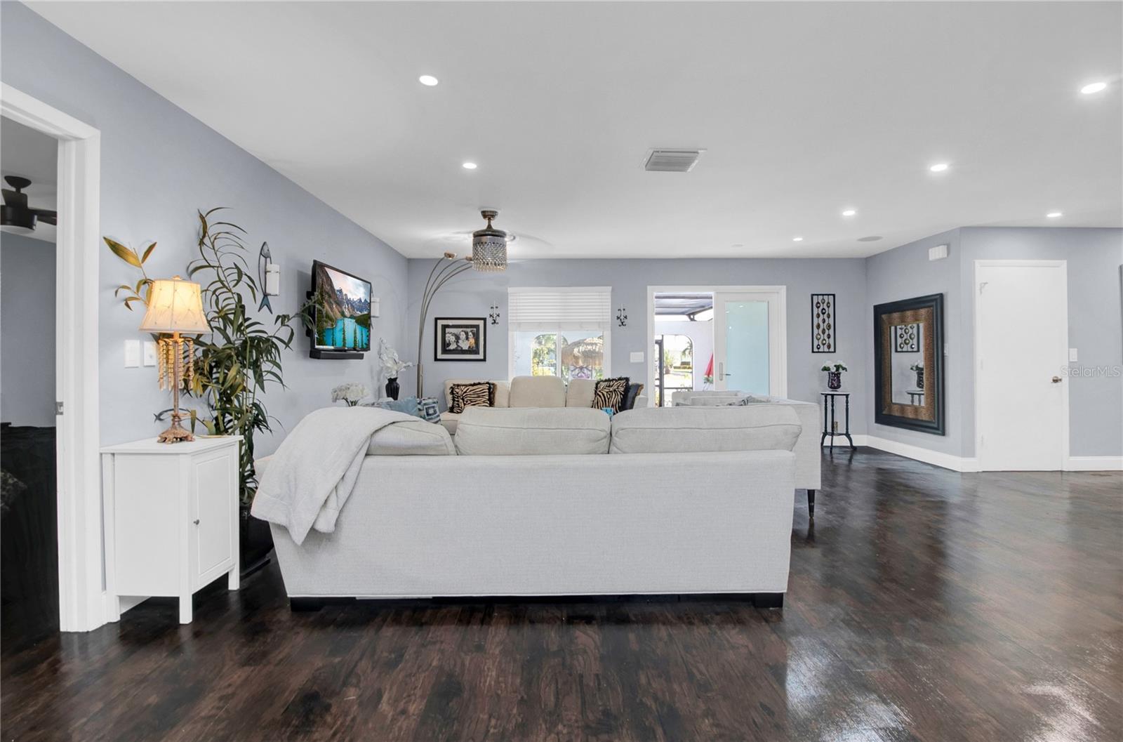 great room - dark wood floors replaced with Grey LV Plank