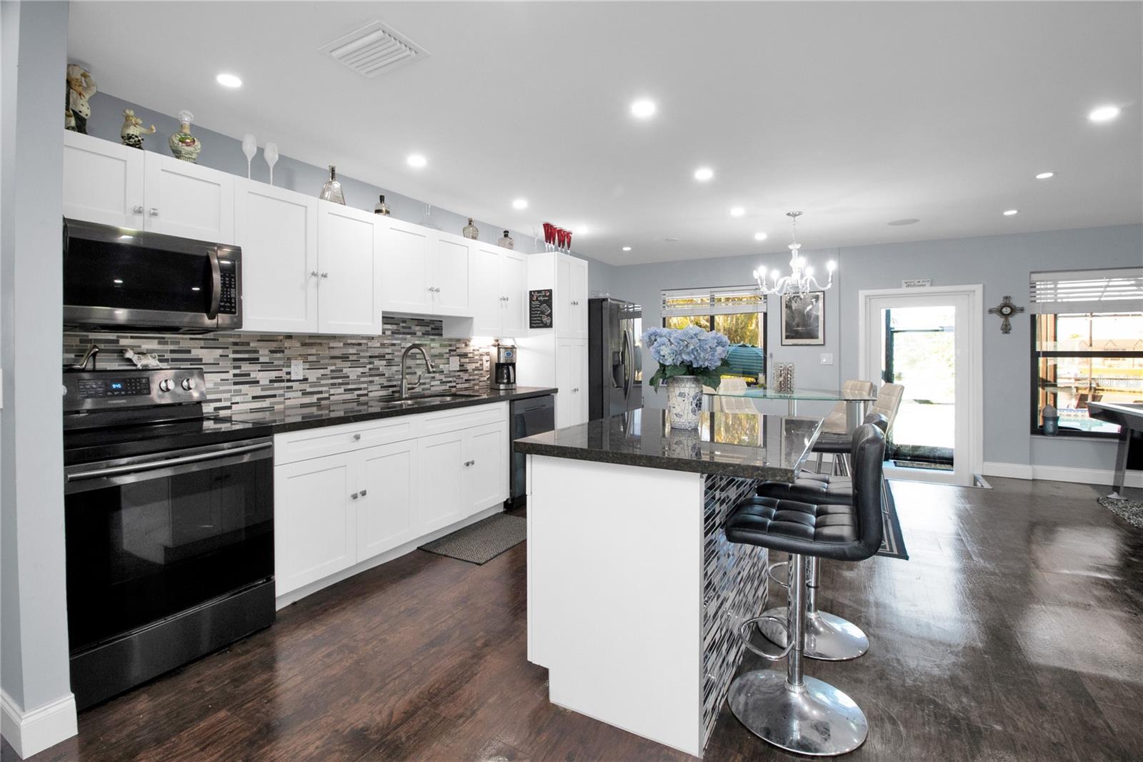 kitchen - dark wood floors replaced with Grey LV Plank