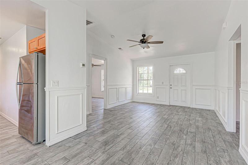 Living Room with doors to Master in foreground and Kitchen