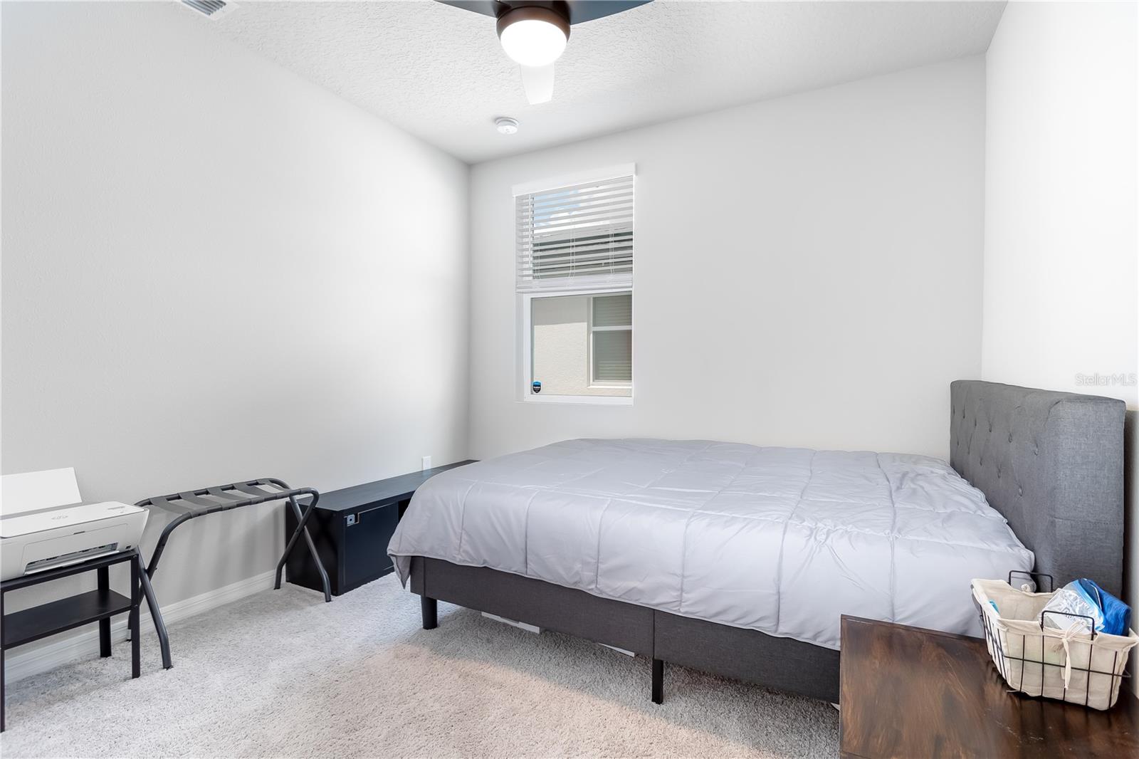Guest bedroom 3, located near garage entrance.