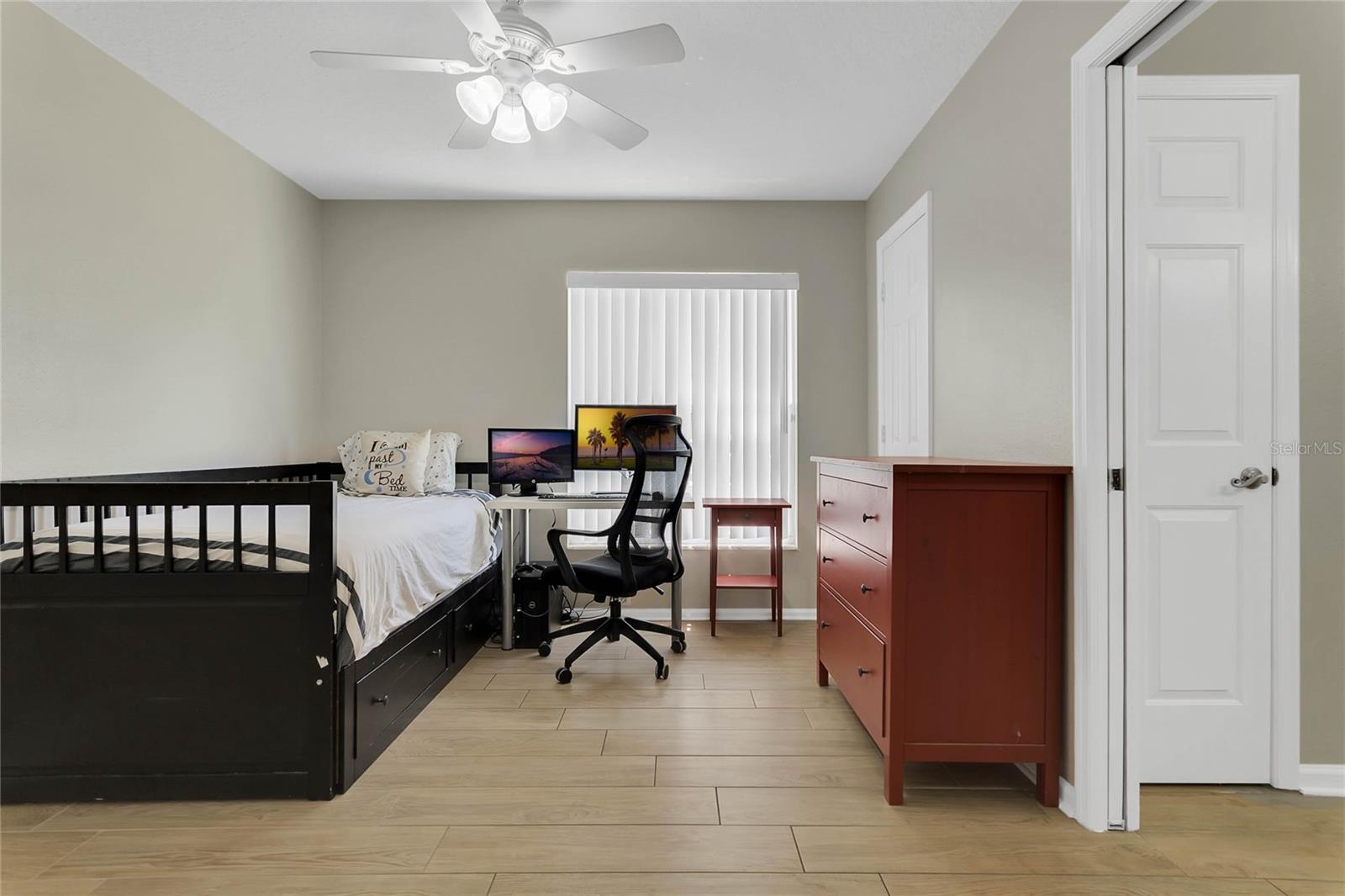 This bedroom shares a jack and Jill bath and separated by space saving pocket doors