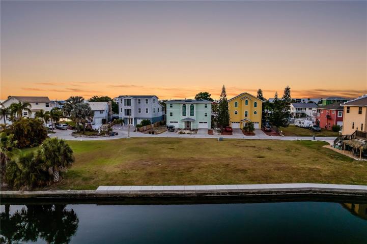 Fantastic View of Water Out Back AND Lovely View of Beautiful Homes Out Front!