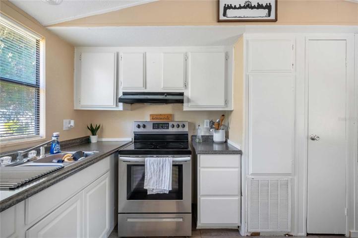 Updated with laminate flooring, ceiling fan, fresh paint, and updated kitchen.