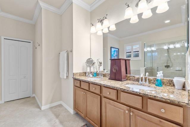 Owners suite Bathroom with dual vanities, large walk-in shower, and garden tub