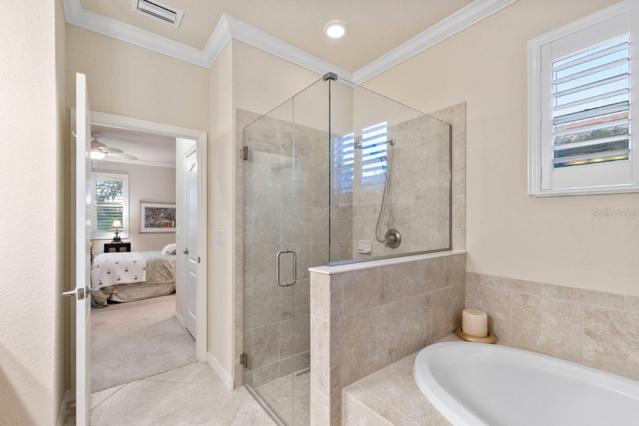 Owners suite Bathroom with dual vanities, large walk-in shower, and garden tub
