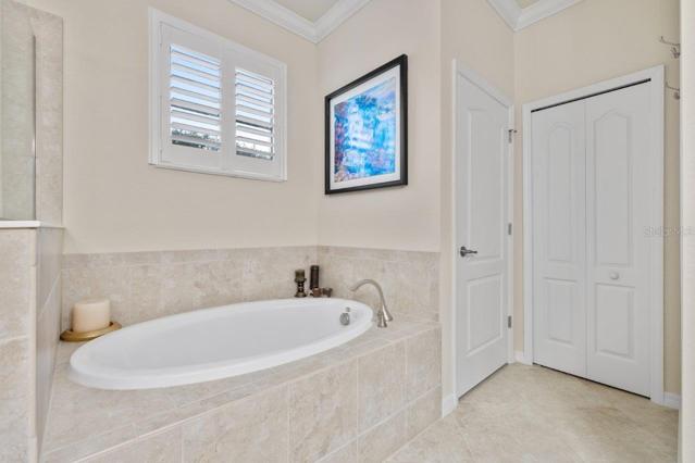 Owners suite Bathroom with dual vanities, large walk-in shower, and garden tub