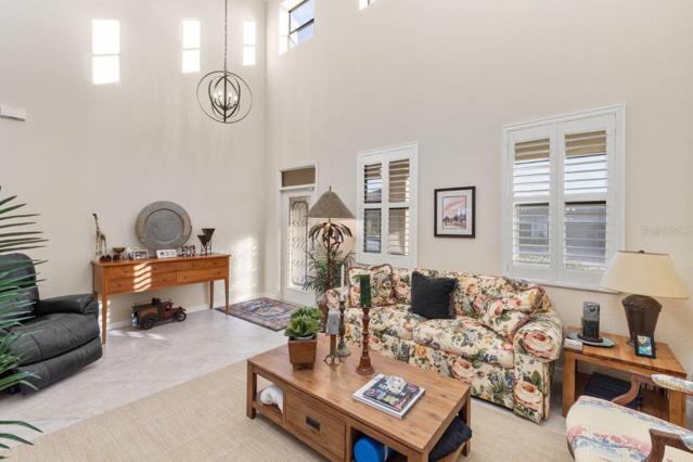 Main entryway and Family room with access to the second floor, the kitchen, and living room.