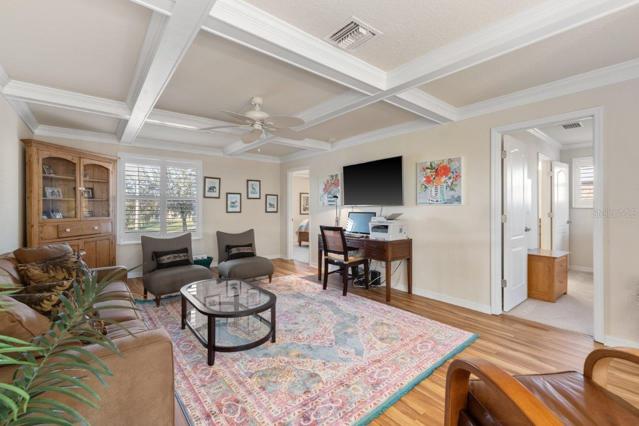 Upstairs Den featuring coffered ceilings and access to all 3 guest bedrooms