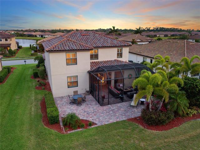 Rear view of home and the Additional extended exposed paver lanai with golf course views