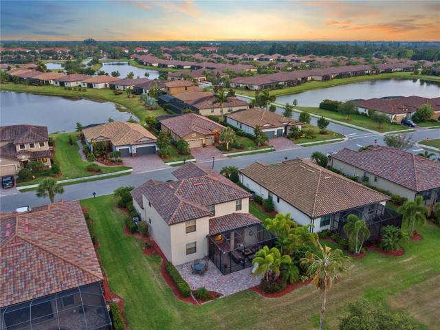 Rear view of home and the Additional extended exposed paver lanai with golf course views