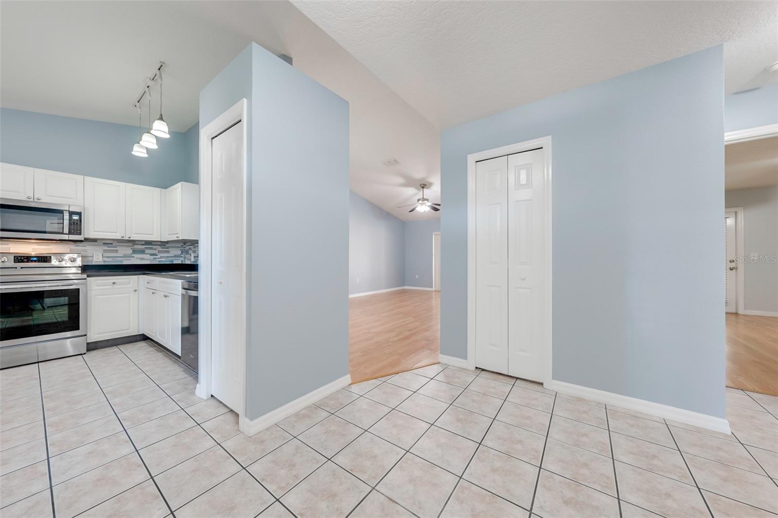 View from foyer into kitchen and living/dining rooms and master on right
