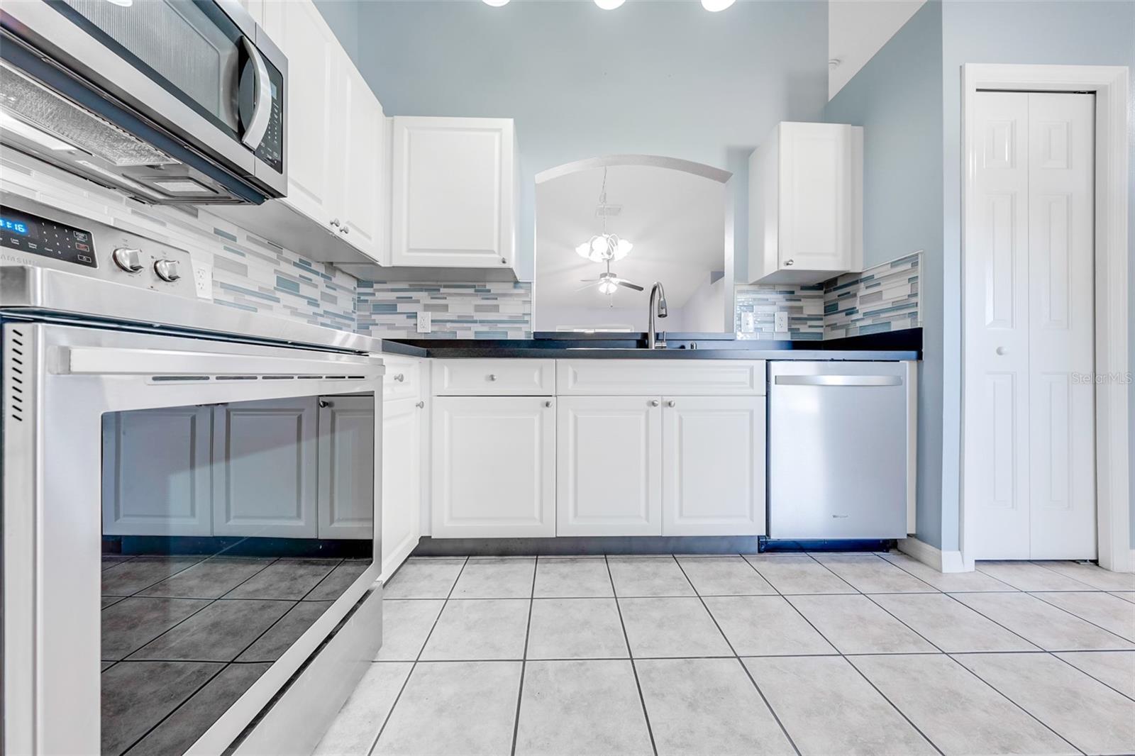 Another view of inviting kitchen with bright, happy blue,white and grey colors