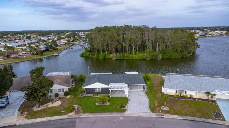 Remodeled Lakefront Home with a Newly Added Pergola that Creates Great Curb Appeal