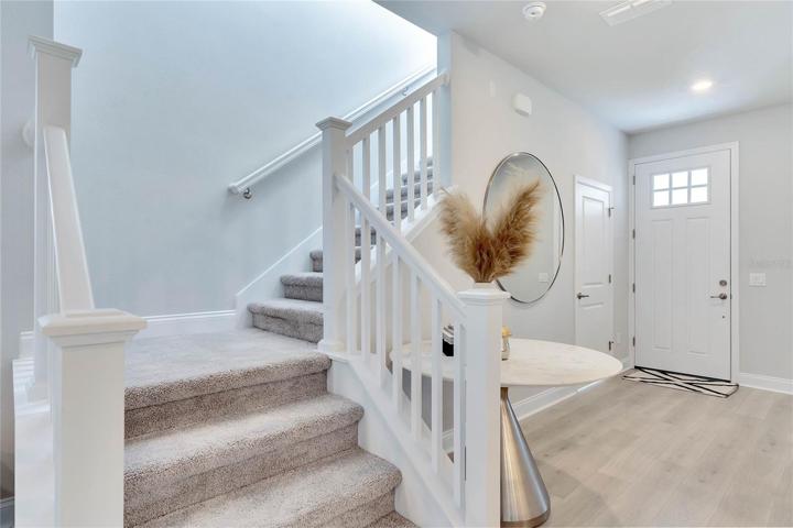 Elegant open rake stairs lead you to the bedrooms and family retreat
