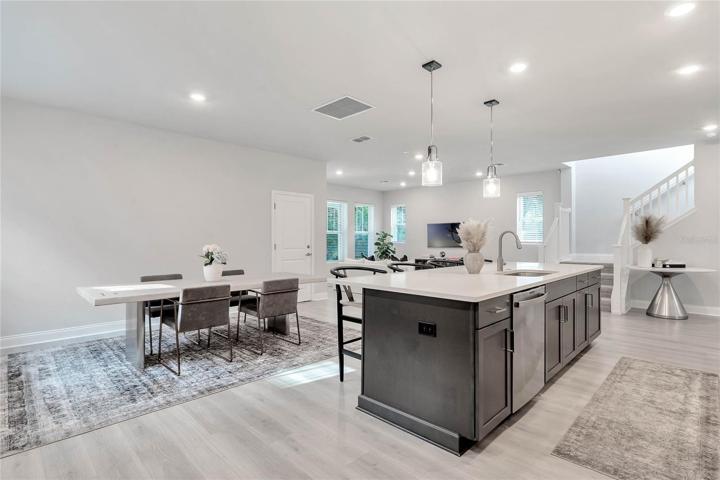 The accent finish on the island complements the white cabinets