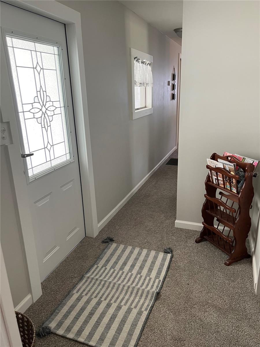 Hallway and door leading to carport
