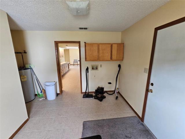 laundry room area leads to kitchen and basement