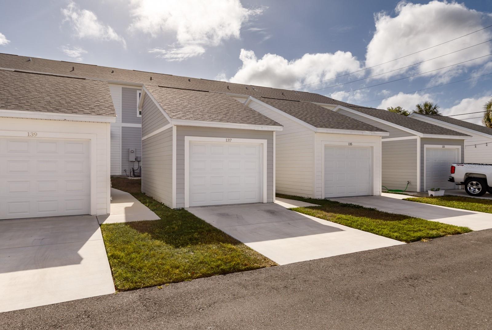 Alley view with garage