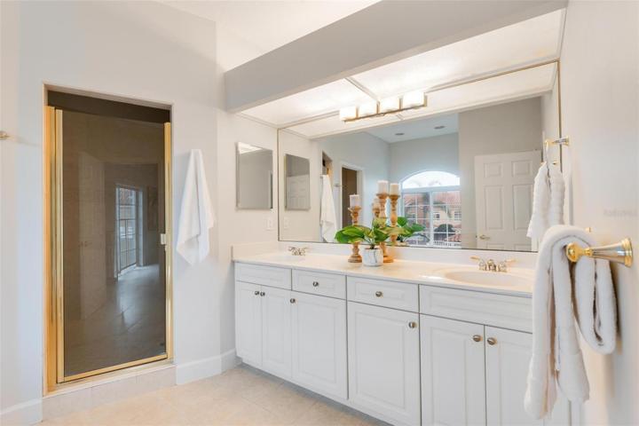 Double vanities in master bath with linen closet
