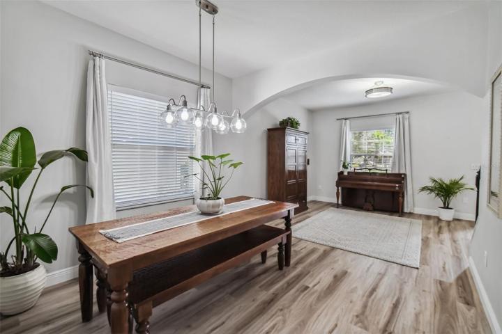 Open concept living and dining rooms are just inside the front foyer, which are accentuated by tall ceilings and abundant natural lighting.