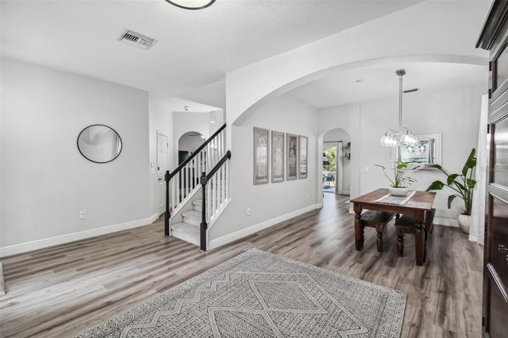 Foyer with open concept living and dining room that leads to the kitchen.