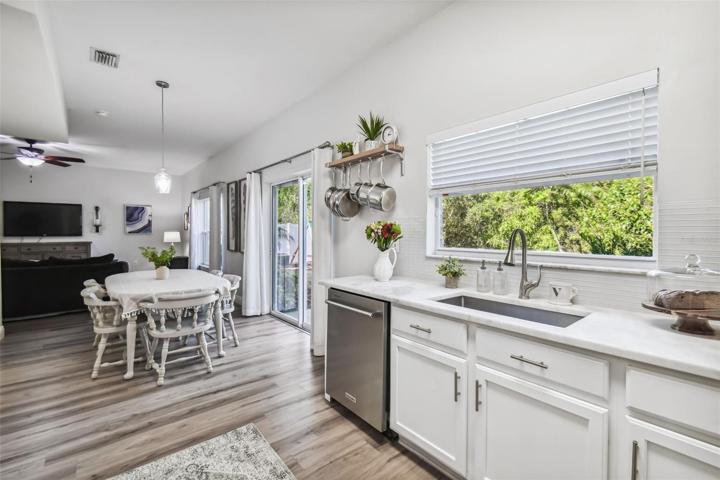 Your breakfast area overlooks the family room with sliding glass doors that lead to your outdoor stone and gravel patio with tranquil views of the conservation area behind the spacious backyard