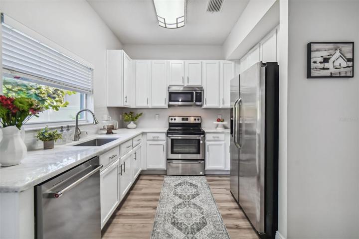 Beautiful kitchen with brand new Dolomite solid stone countertops, freshly painted cabinets and stainless steel appliances.