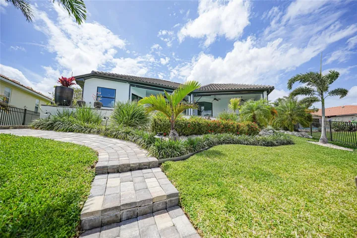 Manicured landscaping with paver walkway to dock