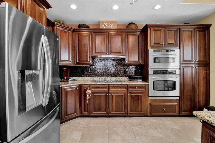 Custom-tiled backsplash adds pizazz to this gorgeous kitchen